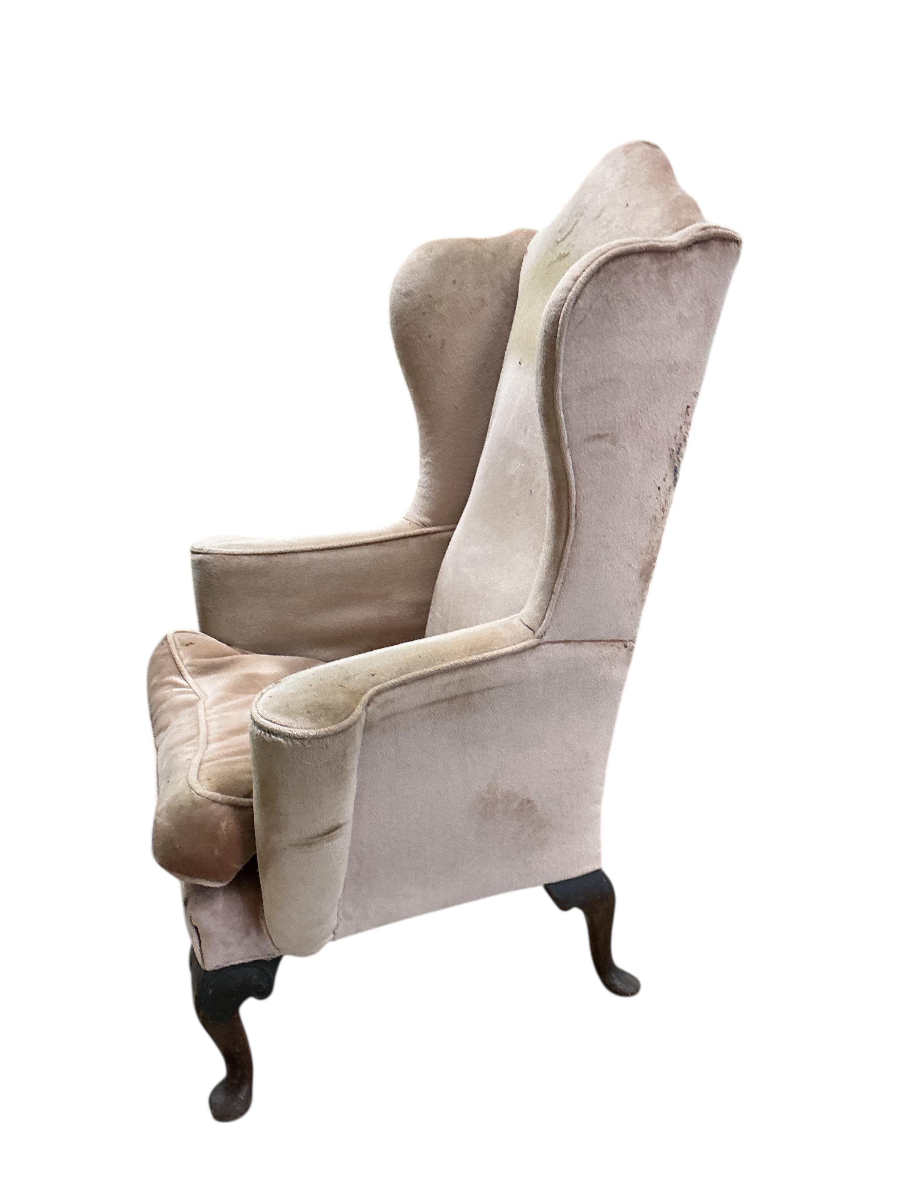 A Queen Anne Revival upholstered wing armchair, width 79cm, depth 60cm, height 116cm